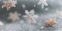 Delicate snowflakes falling on soft knitted fabric creating magical winter atmosphere with bokeh lights and seasonal holiday decorations in background.