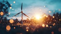 Wind turbine silhouette against dramatic sunset sky with golden bokeh lights and glowing particles, representing renewable energy and sustainable future.