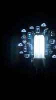 Glowing energy-saving bulb surrounded by digital health icons, DNA, stethoscope, and cloud symbols on dark background, representing medical innovation.
