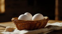 Fresh white eggs in rustic woven basket on natural linen cloth against dark background with soft morning light, farm to table concept for food photography.