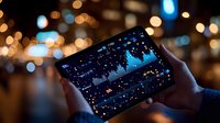 Hands holding smartphone displaying starry night sky scene against blurred city lights background, creating magical contrast between digital screen and bokeh effects.