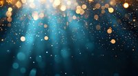 Magical glowing golden bokeh lights and sparkles falling on dark turquoise blue background with rays of light creating dreamy atmospheric effect.