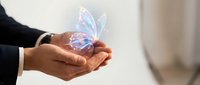 Hands holding glowing holographic butterfly with light effects, representing digital transformation, innovation, and future technology concepts for business presentations.