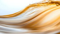 Smooth flowing golden liquid creates elegant waves and curves against white background, abstract luxury design element for cosmetic and beauty products.