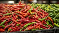 Fresh red and green chili peppers piled in market display, showing vibrant colors and textures of spicy ingredients for cooking and food preparation.