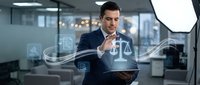 Professional businessman in dark suit interacting with holographic justice scales and digital interface elements in modern corporate office environment.