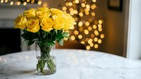 Yellow roses in glass vase on marble table with warm bokeh lights creating cozy romantic atmosphere for home decor and special occasions.