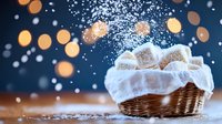 Fresh homemade donuts dusted with powdered sugar in wicker basket with falling snow and warm bokeh lights creating festive winter atmosphere.