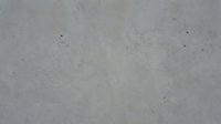 Grunge concrete wall texture with subtle cracks and dust particles, suitable for backgrounds, overlays, and industrial design projects.