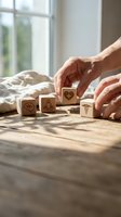 Senior hands arranging wooden blocks with healthcare symbols on table near window for wellness planning and medical decision making.