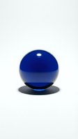 Blue glass sphere with shadow on white background isolated for modern design and decoration projects.