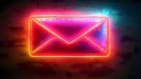 Glowing neon mail envelope sign with vibrant pink and orange lights against dark background, modern communication concept for business and technology.