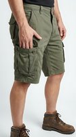 Man wearing olive green cargo shorts with multiple pockets and brown lace-up boots, showcasing casual outdoor workwear style for men's fashion and utility clothing.
