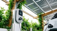 Electric vehicle charging station with solar panels and green plants creating sustainable energy solution for eco-friendly transportation and renewable power.