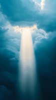 Dramatic sunbeam breaking through dark turquoise storm clouds, creating ethereal light shaft effect against moody sky. Spiritual and atmospheric background.