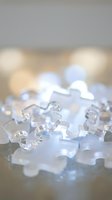 Clear crystal ice cubes melting with soft bokeh lights creating elegant refreshing beverage photography for summer drinks and cocktail presentations.