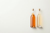 Two glass bottles with cork stoppers containing rose and white wine arranged minimally on light background, casting subtle shadows. Suitable for wine marketing.