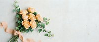 Elegant peach rose bouquet with eucalyptus and silk ribbon on white textured background for wedding invitations and romantic greeting cards.