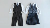 School uniforms for boy and girl featuring classic vest, white shirt, tie, pleated skirt and dress pants on white background, ready for design use.