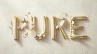 Word PURE spelled with white asparagus, garlic, and fresh herbs on a light textured background, evoking organic, natural food concepts.