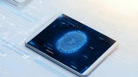 Digital fingerprint scan on tablet device with glowing blue biometric interface and circuit pattern background showing cybersecurity authentication technology.