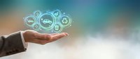 Businessman hand holding glowing digital icons representing industry, manufacturing, and logistics network solutions for enterprise operations.
