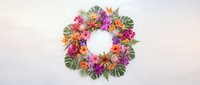 Tropical flower wreath with vibrant hibiscus, plumeria and palm leaves on white background. Summer decoration for wedding, party invitations.