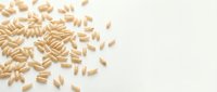 Scattered peanuts on white background, isolated ingredient for food packaging, cooking, nutrition, and culinary design projects.