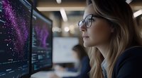 Young blonde woman data scientist analyzing purple visualization on computer screen in modern office workspace wearing glasses.