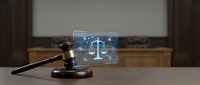 Wooden judge gavel with digital justice scale hologram on courtroom desk for legal technology and modern law practice concepts.