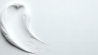 White cream cosmetic texture smear on clean background for skincare beauty product advertising and makeup application concepts.