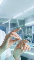 Scientist hands manipulating holographic data interface in modern laboratory environment for medical research and digital healthcare innovation.
