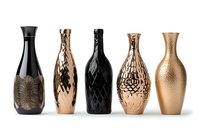 Modern decorative vases in black and metallic rose gold colors with textured patterns arranged in row on white background, isolated luxury home decor elements.
