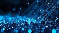 Glowing blue bokeh lights and sparkles on dark background with diagonal light rays creating magical atmospheric effect. Suitable for festive designs.