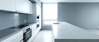 Modern minimalist kitchen interior with white cabinets, gray countertops and backsplash. Clean contemporary design with built-in appliances and natural light.