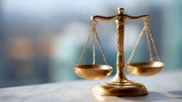 Golden scales of justice on blurred background symbolizing law, legal system, judgment, and equality in courtroom or office setting.
