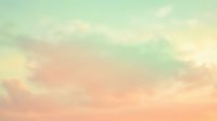 Soft pastel gradient sky with fluffy clouds in mint green, peach and cream tones creating dreamy atmospheric background for wellness and meditation designs.