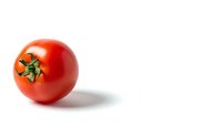 Fresh red tomato with green stem isolated on white background for healthy cooking and nutrition concepts.