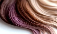 Smooth flowing strands of blonde and pink hair blend together in soft waves creating an elegant ombre effect against white background for beauty and fashion designs.