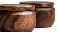 Handcrafted wooden bowls with rich grain pattern and smooth curved design showcase artisanal woodworking detail in dark brown tones against neutral background.