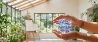 Hands cupping glowing energy spiral in modern eco-friendly home interior with plants and natural light for wellness and sustainability concepts.