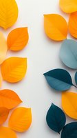 Orange and teal paper leaves arranged on white background creating modern minimalist composition with soft shadows. Suitable for seasonal designs.