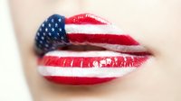 Patriotic lips painted with American flag stars and stripes design for Independence Day celebration and national pride expression.