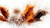Flying spices explosion with turmeric, paprika and black pepper powder creating dynamic motion of orange and brown colors on white background.