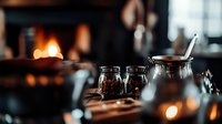 Atmospheric restaurant table setting with glowing candles and glass jars in dark moody lighting, creating intimate dining ambiance for menu design and marketing.