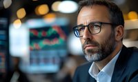 Thoughtful middle-aged businessman with glasses and gray beard looking away pensively in modern office environment with blurred bokeh lights background.