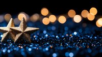 Glittering gold star decorations on dark blue sparkly surface with warm bokeh lights in background creating festive holiday atmosphere.