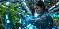 Young Asian female scientist examining plants in modern greenhouse laboratory with futuristic blue light visualization of data networks for agriculture research.
