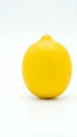 Fresh yellow lemon isolated on white background for culinary design and healthy food concepts.