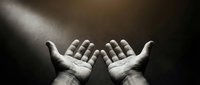 Open hands reaching upward in dramatic lighting with beam of light from above creating spiritual prayer or hope concept for religious content.